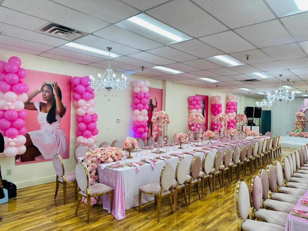Balloon columns and portraits along the hall wall